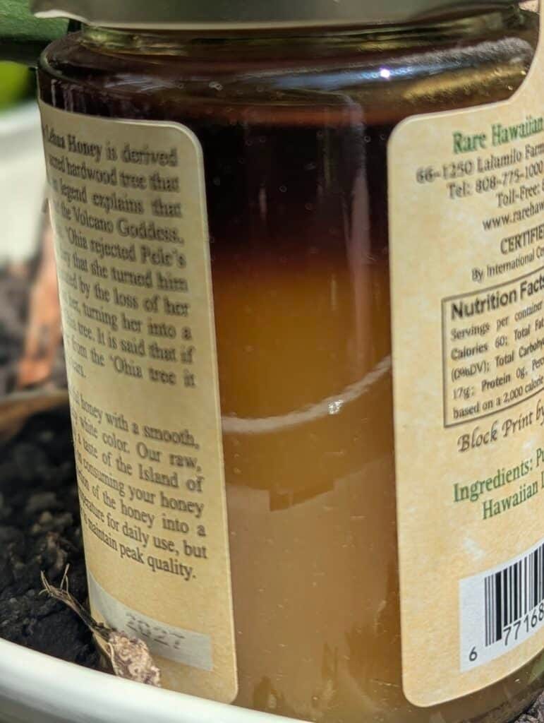 Raw Hawaiian honey jar from Mauna Loa with detailed label.